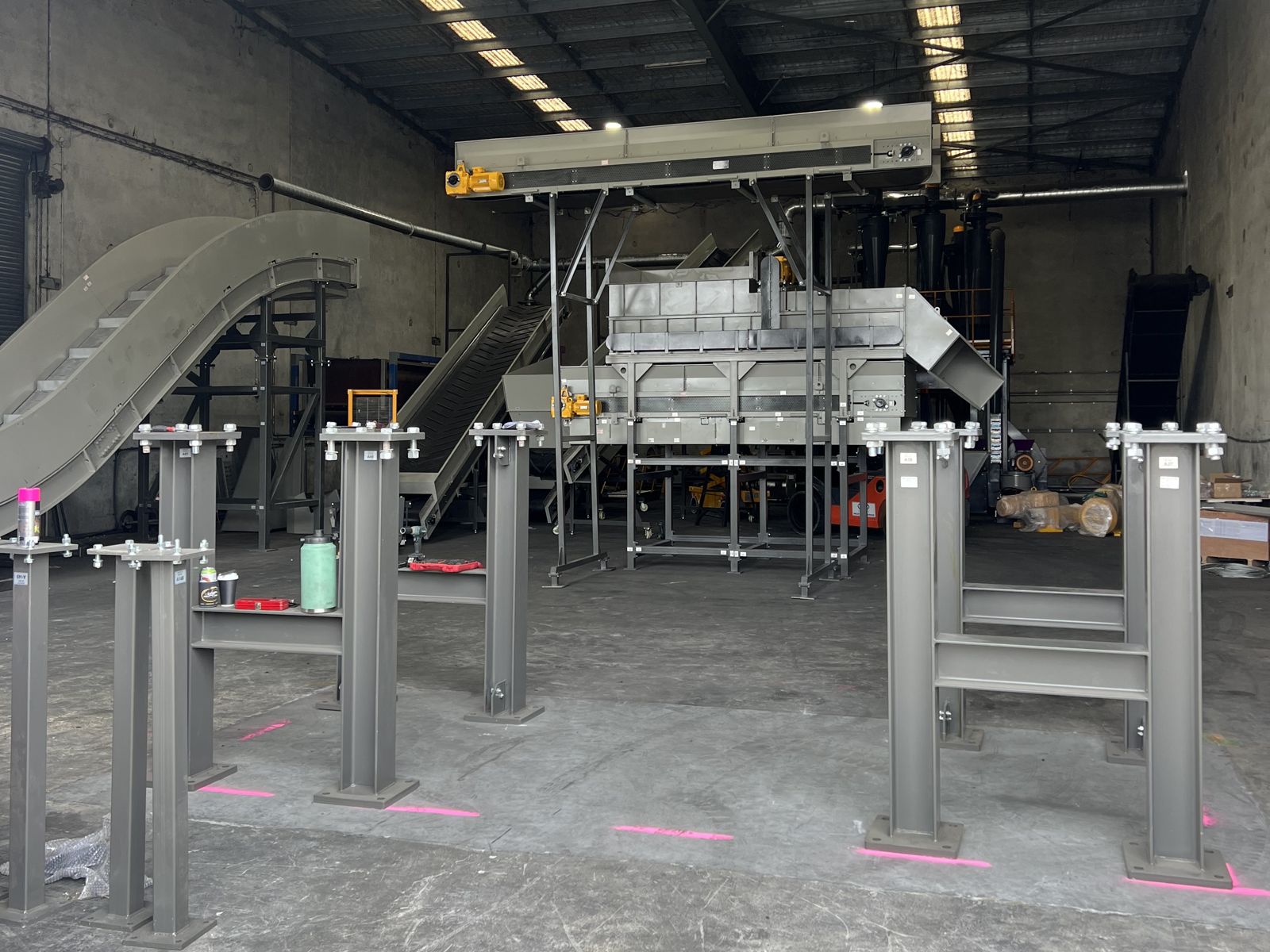Machine being installed on steel stands in a workshop